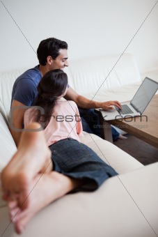 Above view of a couple using a laptop