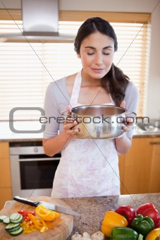 Portrait of a woman smelling a sauce