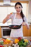 Portrait of a happy woman preparing a dish