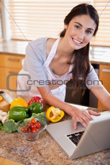 Portrait of a young woman looking for a recipe on the internet