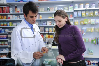 Pharmacist advising client at pharmacy