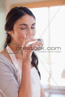 Portrait of a smiling woman drinking water
