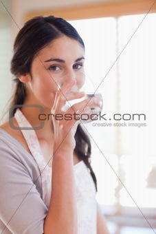 Portrait of a beautiful woman drinking water