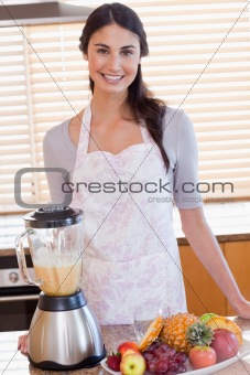 Portrait of a woman posing with a blender