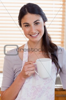 Portrait of a woman holding a cup of coffee