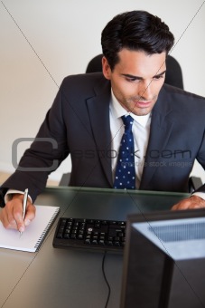 Portrait of a focused businessman taking notes