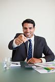 Portrait of a businessman pointing at the viewer