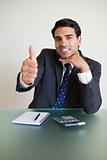 Portrait of a young accountant with the thumb up