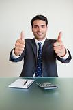 Portrait of a young accountant with the thumbs up