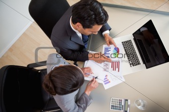 Sales persons studying statistics