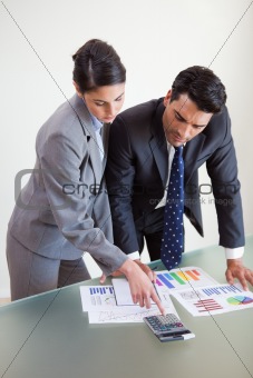 Portrait of focused sales persons studying their results