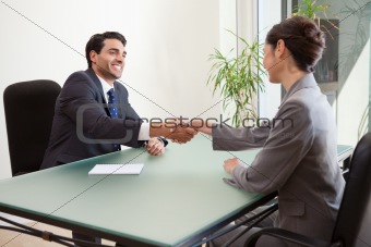 Smiling manager interviewing a good looking applicant