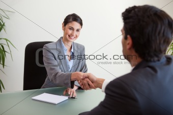Manager shaking the hand of a customer