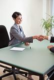 Portrait of a manager shaking the hand of a customer