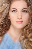Portrait of the beauty young blond girl with curly hair