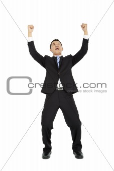 Excited young  business man with arms raised in success