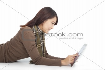young woman with touch pad while lying on floor