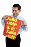Retail salesman holding a sale sign banner