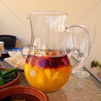 making a summer mix - jug with red wine, orange juice, ice and c