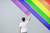 young man painting rainbow