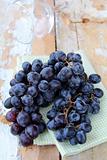 black sweet grapes on wooden table