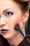 Beautiful woman with makeup brush