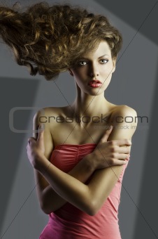 pretty girl with great hair style, her arms are crossed. 