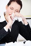 Businesswoman wiping her nose.