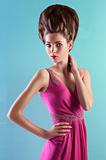 young woman in elegant pink dress and elegant up-do
