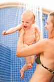 Young mother and happy baby taking shower

