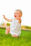 Happy baby playing on grass