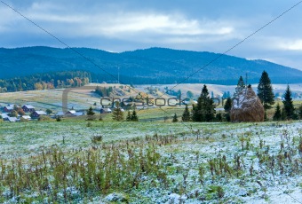 First winter snow and autumn mountain village