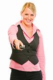 Happy modern business woman with TV remote control in hand
