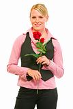 Smiling modern business woman with red roses in hand
