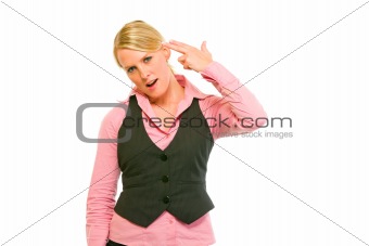 Dissatisfied modern business woman shooting herself with gun shaped hand
