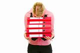 Tired female business clerk put her head on folders stack
