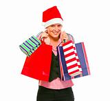 Happy female business secretary in Santa Hat with shopping bags
