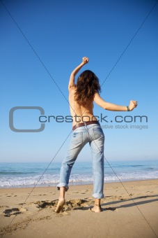 dancing happy woman at seashore