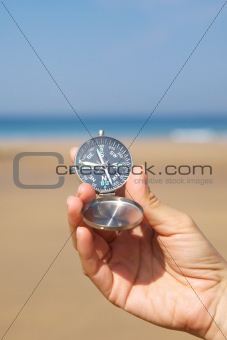 woman hand with silver compass