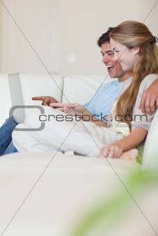 Portrait of a couple using a laptop