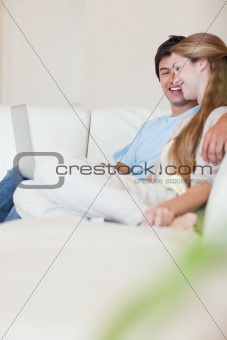Portrait of a young couple using a laptop