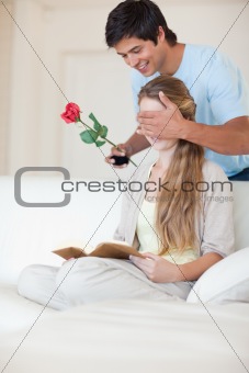 Portrait of a man offering a rose to his girlfriend