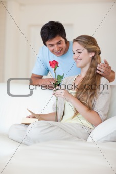 Portrait of a man offering a rose to his fiance