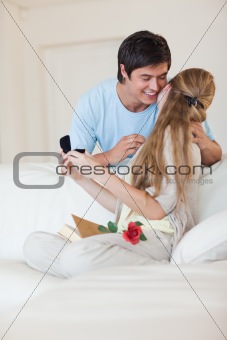 Portrait of a man offering a jewel to his girlfriend