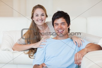 Smiling couple watching television