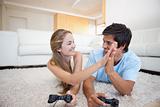 Playful young couple playing video games