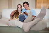 Relaxed young couple watching television