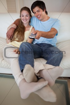 Portrait of a relaxed couple watching television