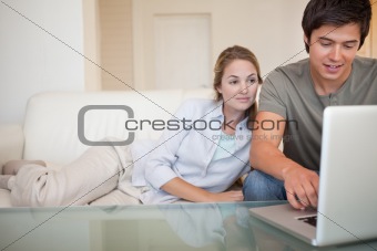 Relaxed couple using a laptop