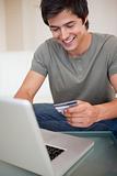 Portrait of a young man shopping online